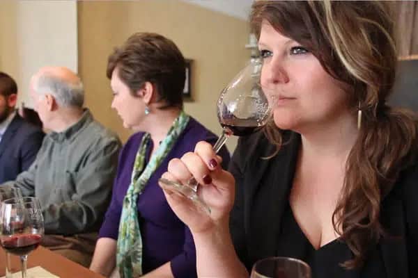 People tasting wine at a table